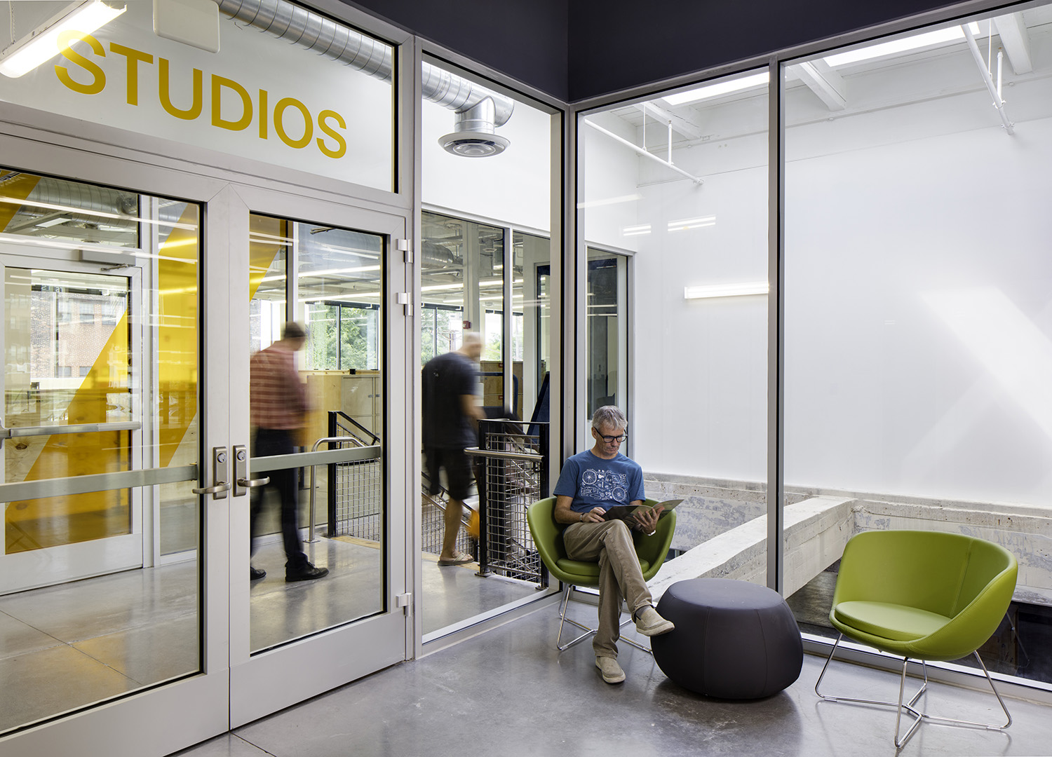 A photo of a man in a conference room.