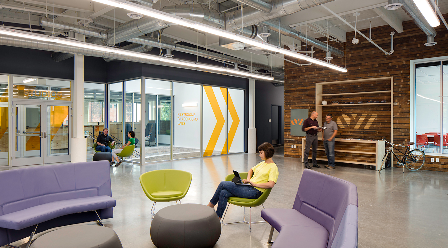 A photo of people in the lobby of a building.
