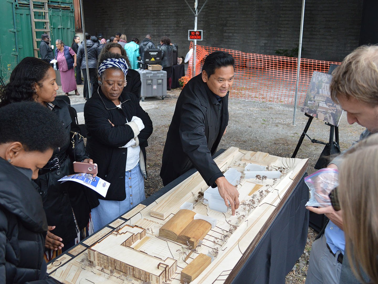 A photo of a man explaining an architectural model.
