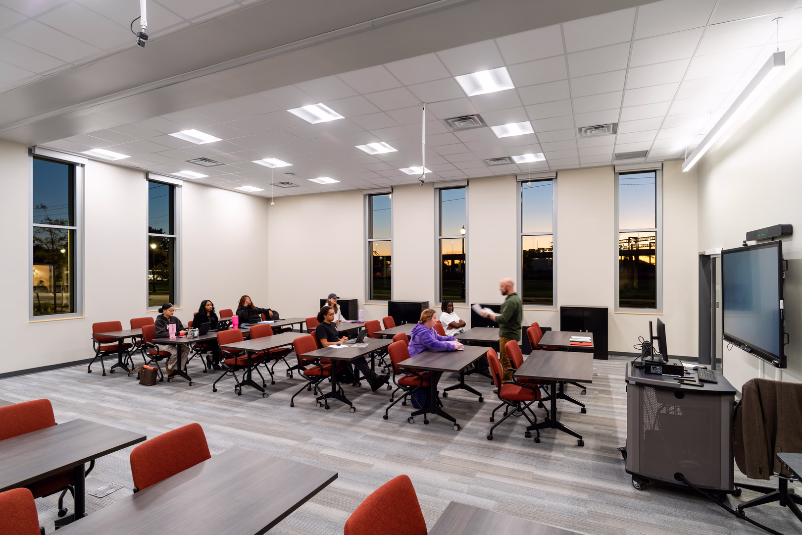 An adult classroom with students looking at a teacher.