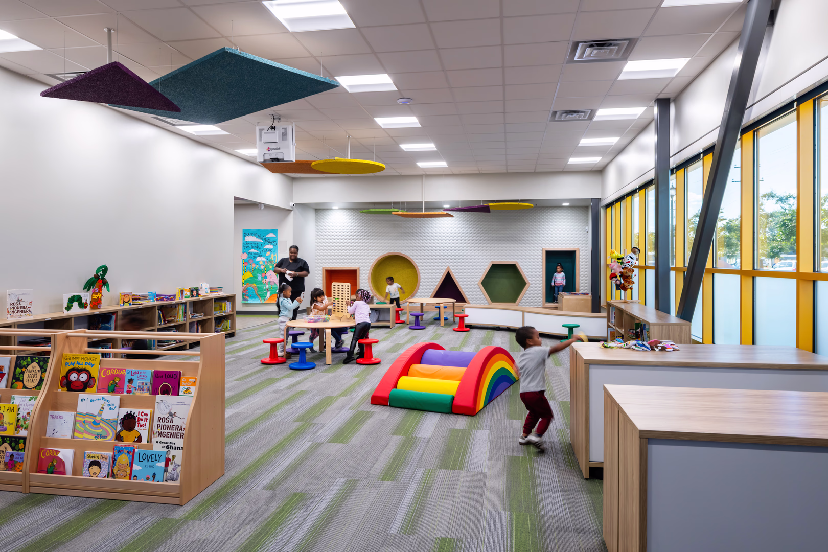 A preschool library with students playing.
