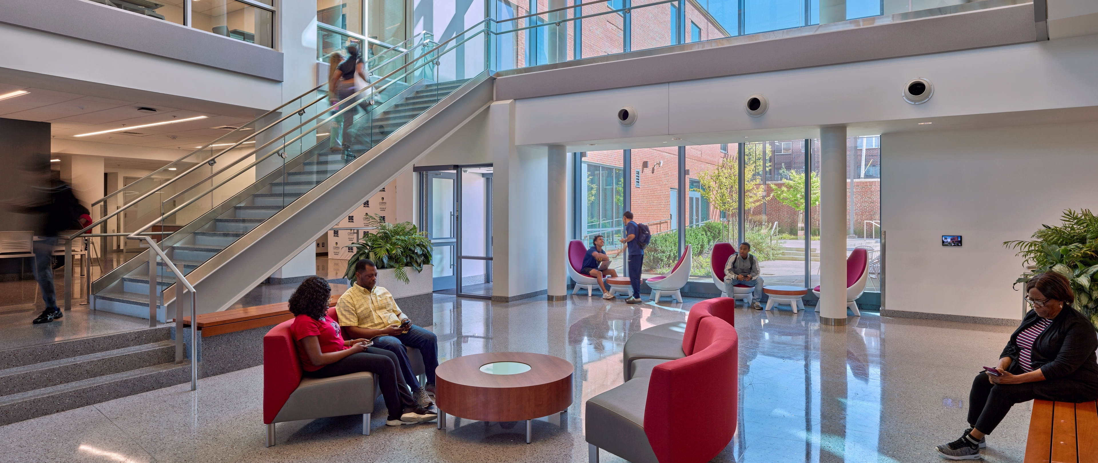 Community members gather inside the lobby of the College of Business at Coppin State University.