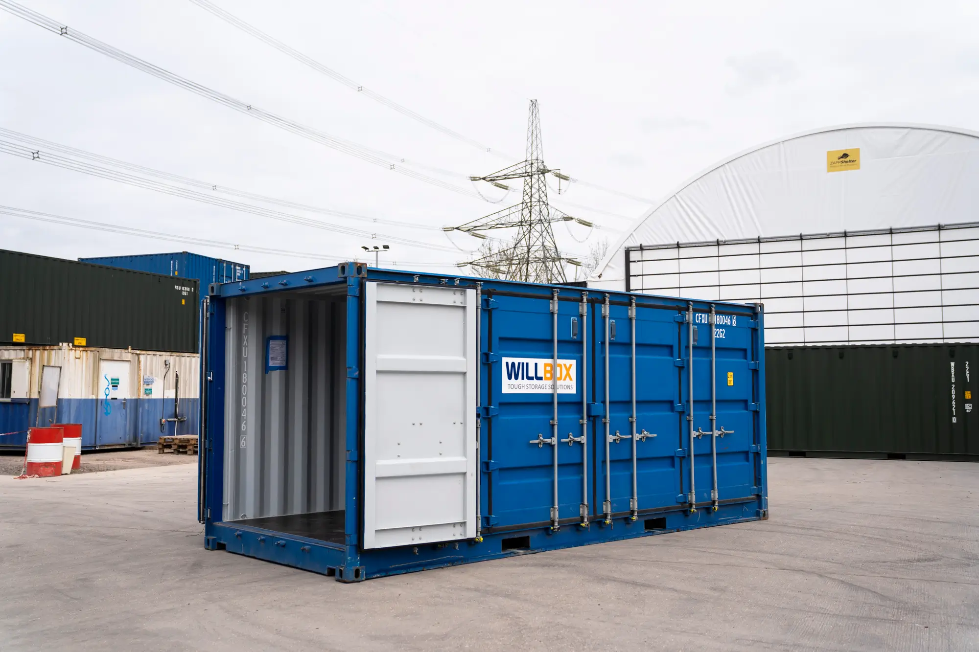 Blue open-sided shipping container with Willbox written on the side.