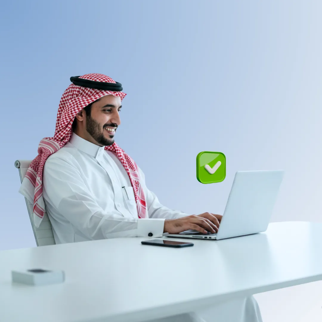 A Saudi man setting on his desk
