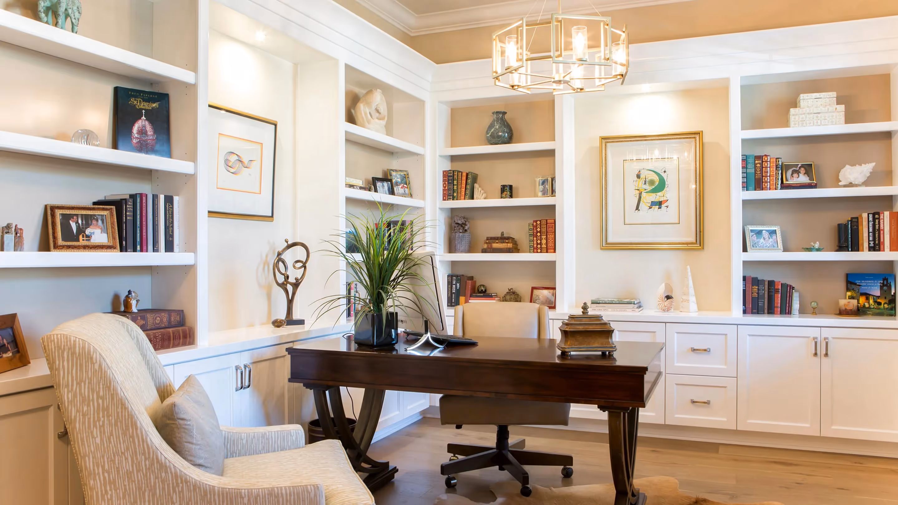 A beautiful study with built-in shelving and cabinets.