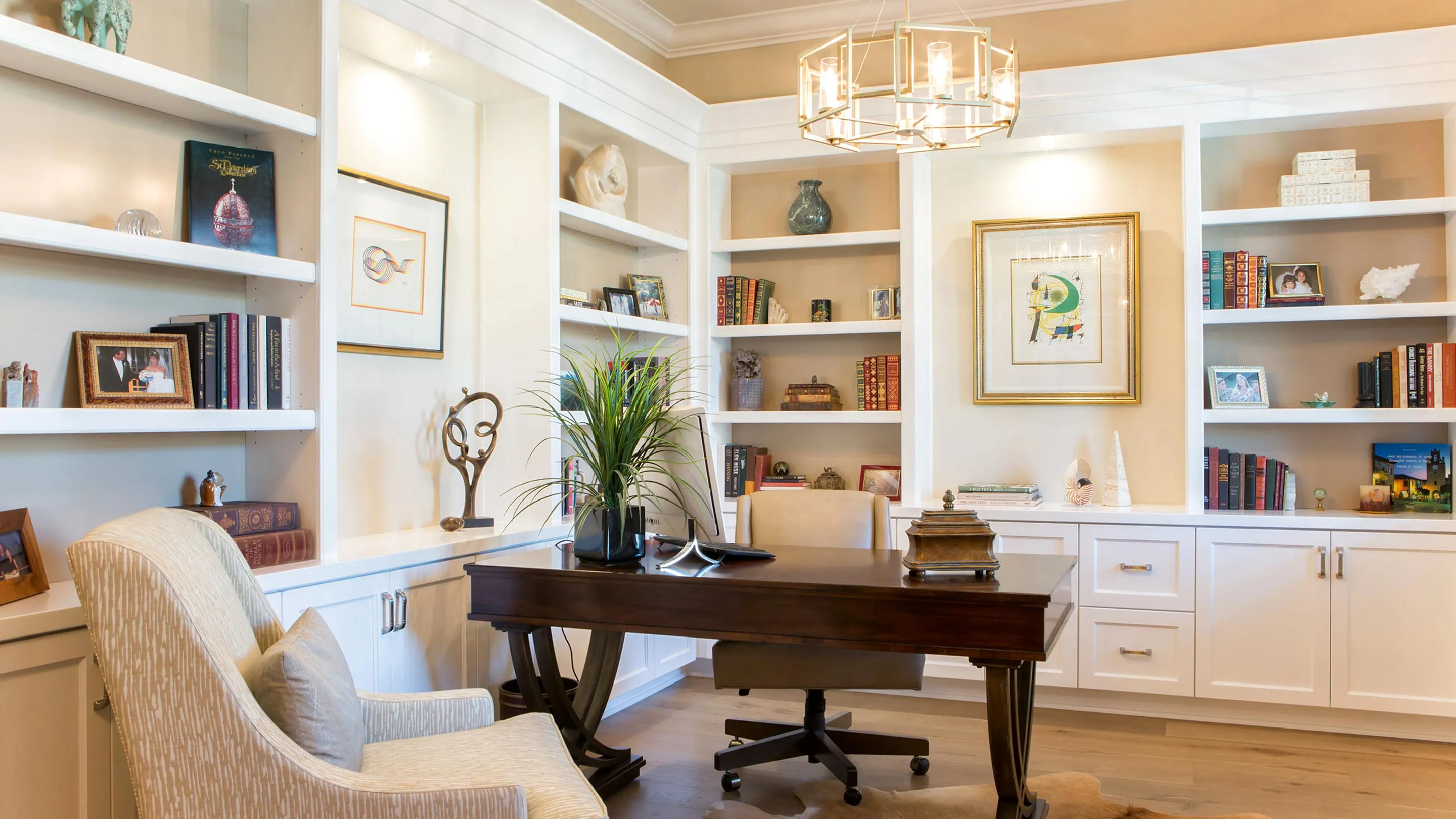 A beautiful study with built-in shelving and cabinets.