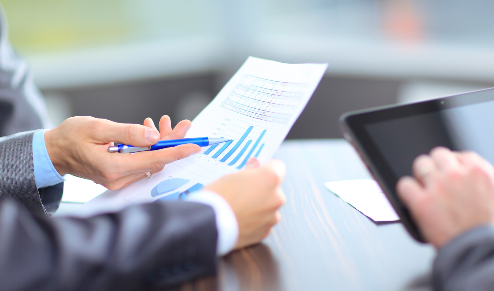 Image of businessman showing a chart to another businessman representing In-depth Research before and after Launch.