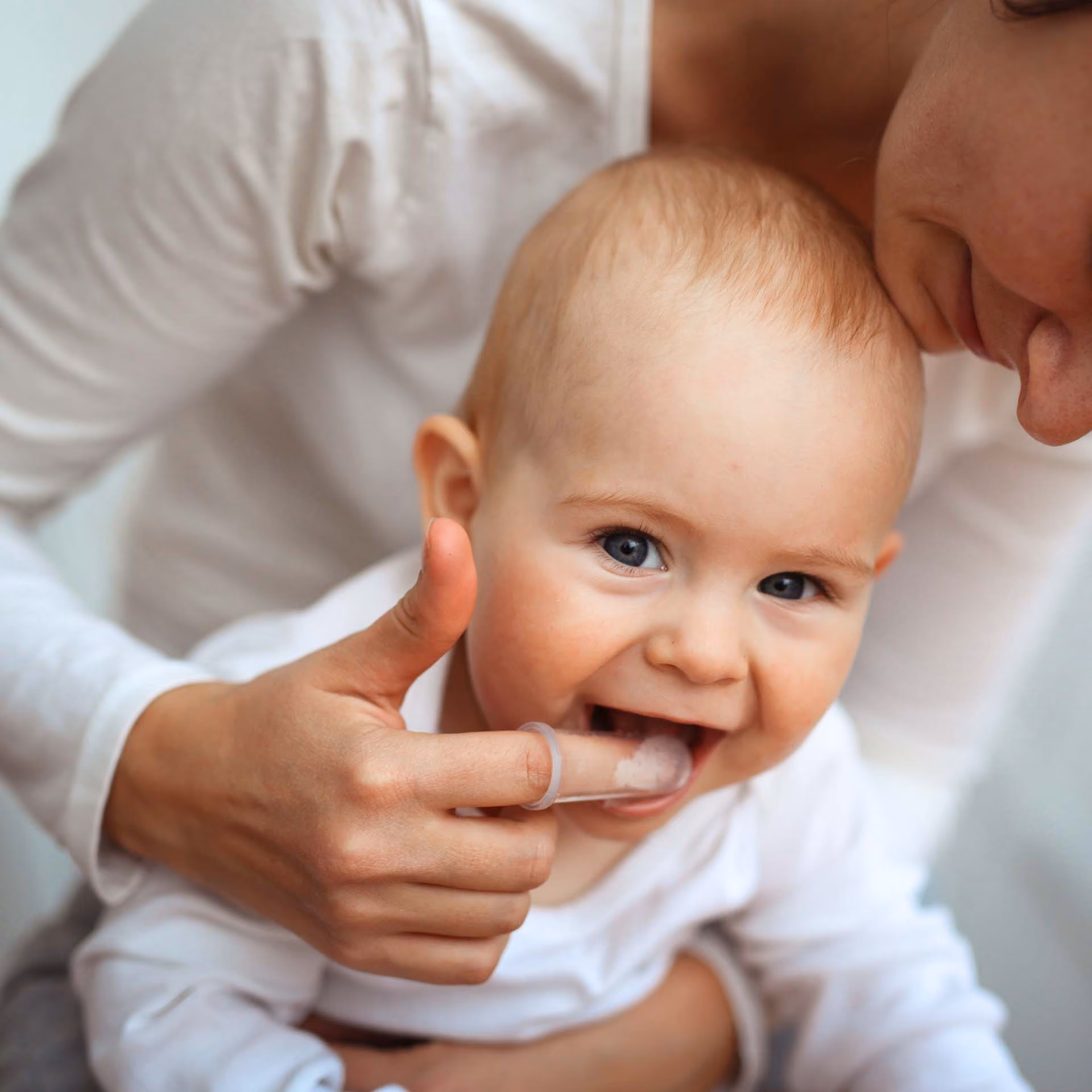 Baby brushing teeth with mom, promoting early dental hygiene habits at Bite Pediatric Dentistry