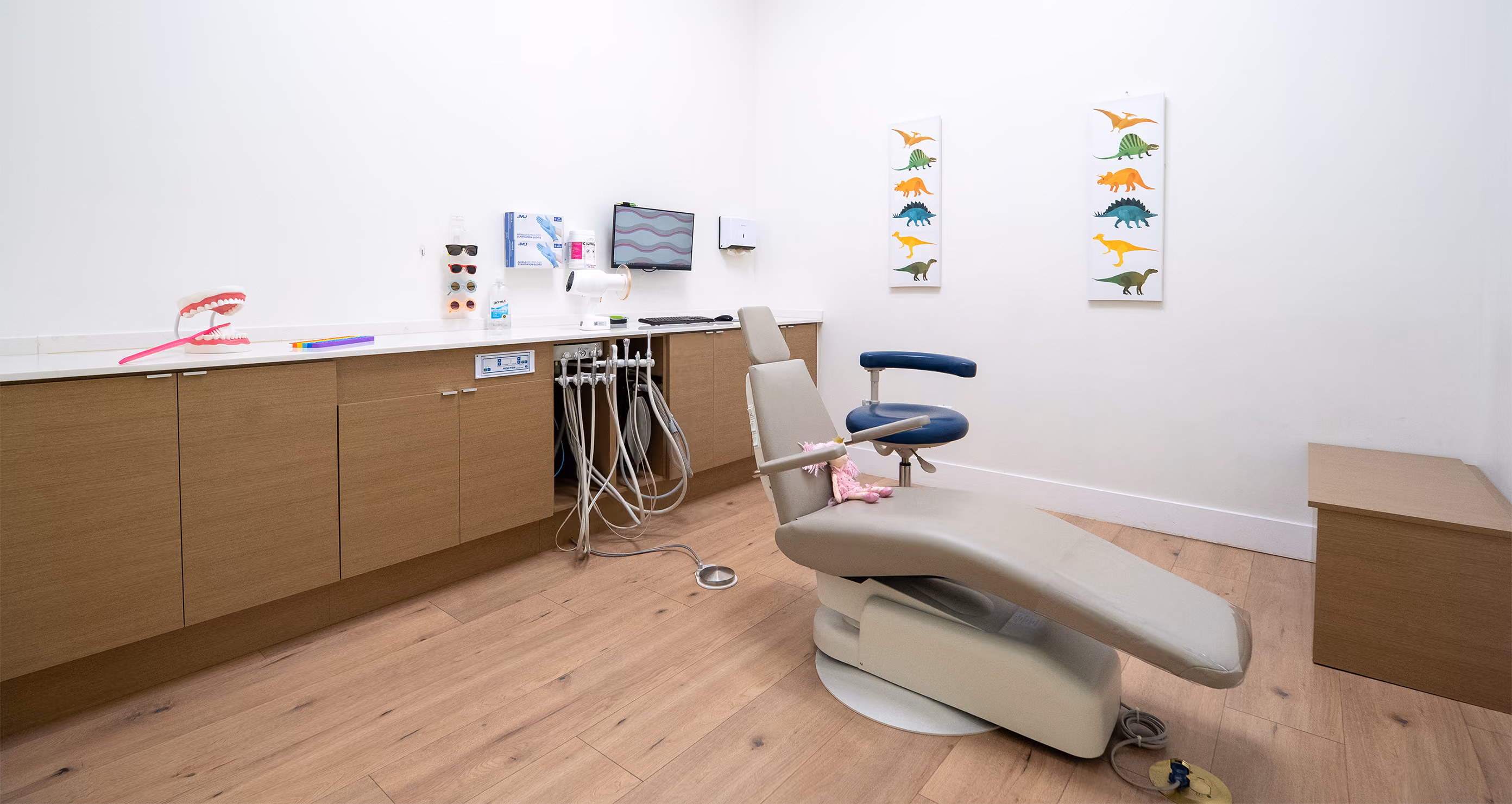 Treatment room at Bite Pediatric Dentistry with a TV mounted on the ceiling to keep children entertained during procedures