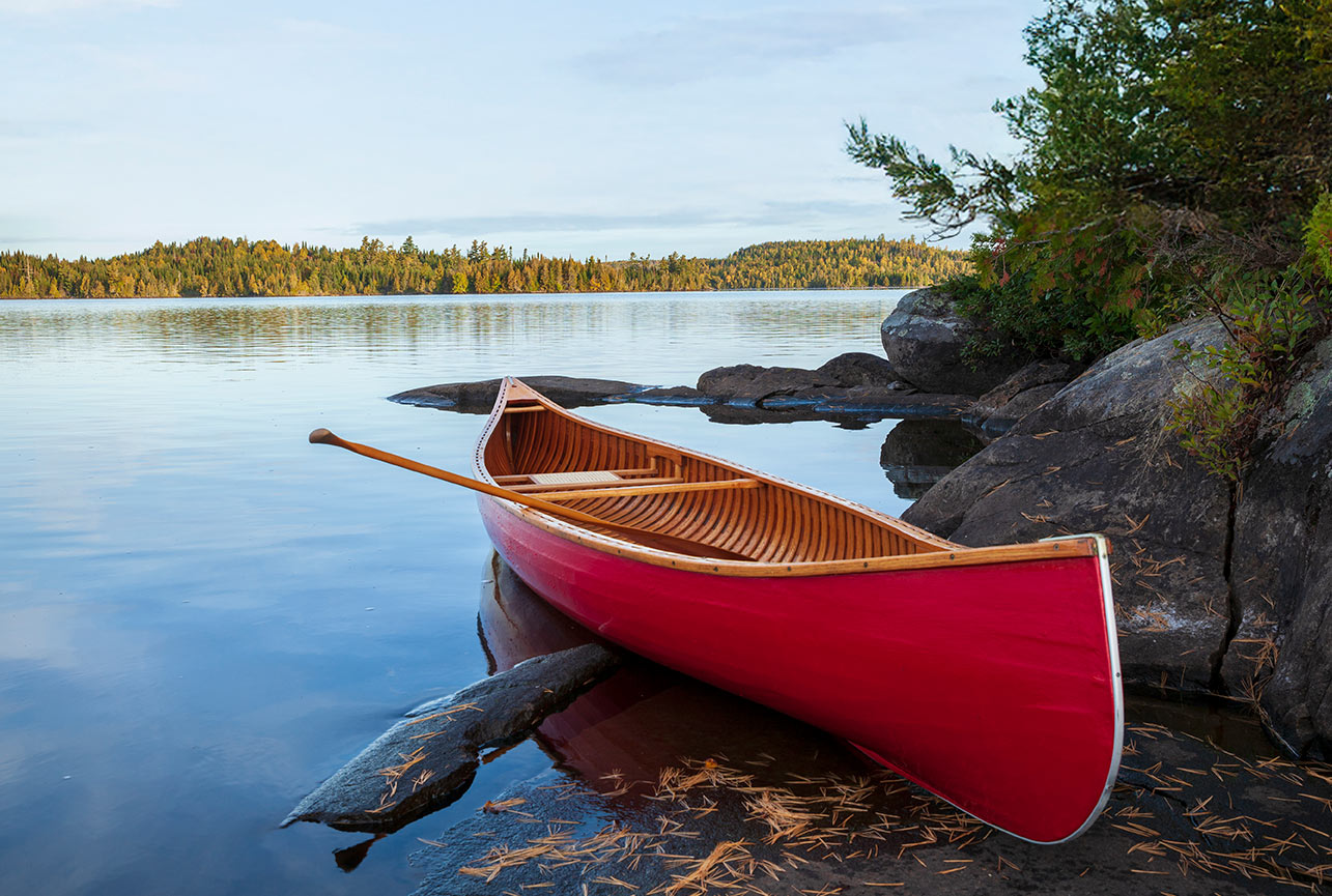 Image of a canoe on the shore of a lake