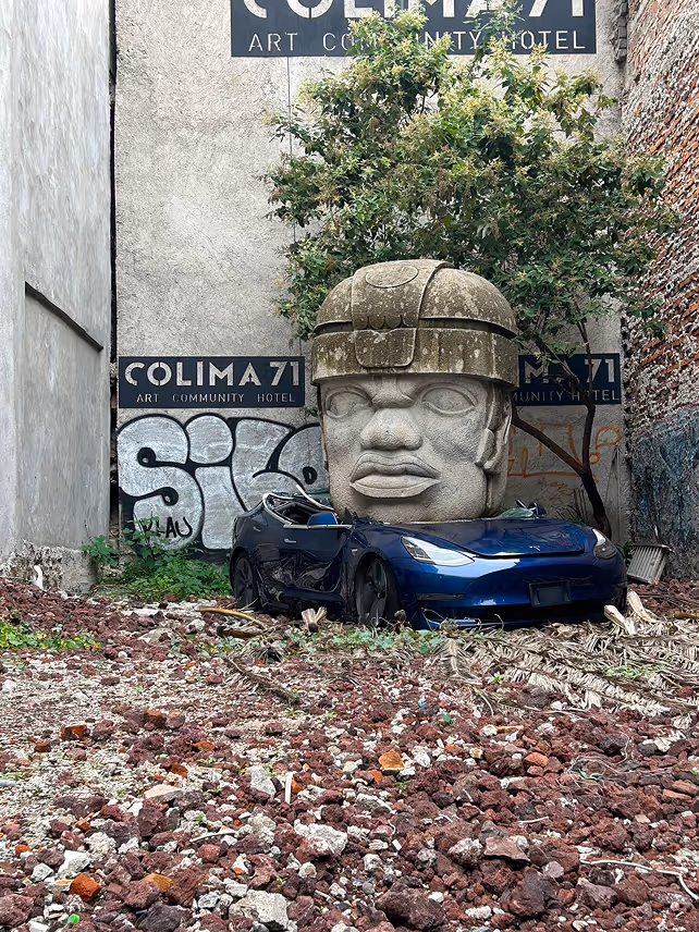A Tesla crushed by an indigenous sculpture, provocative urban art in Mexico