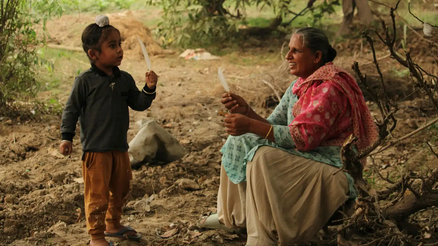 An Indian type 2 diabetic grandmother playing with her granddaughter.