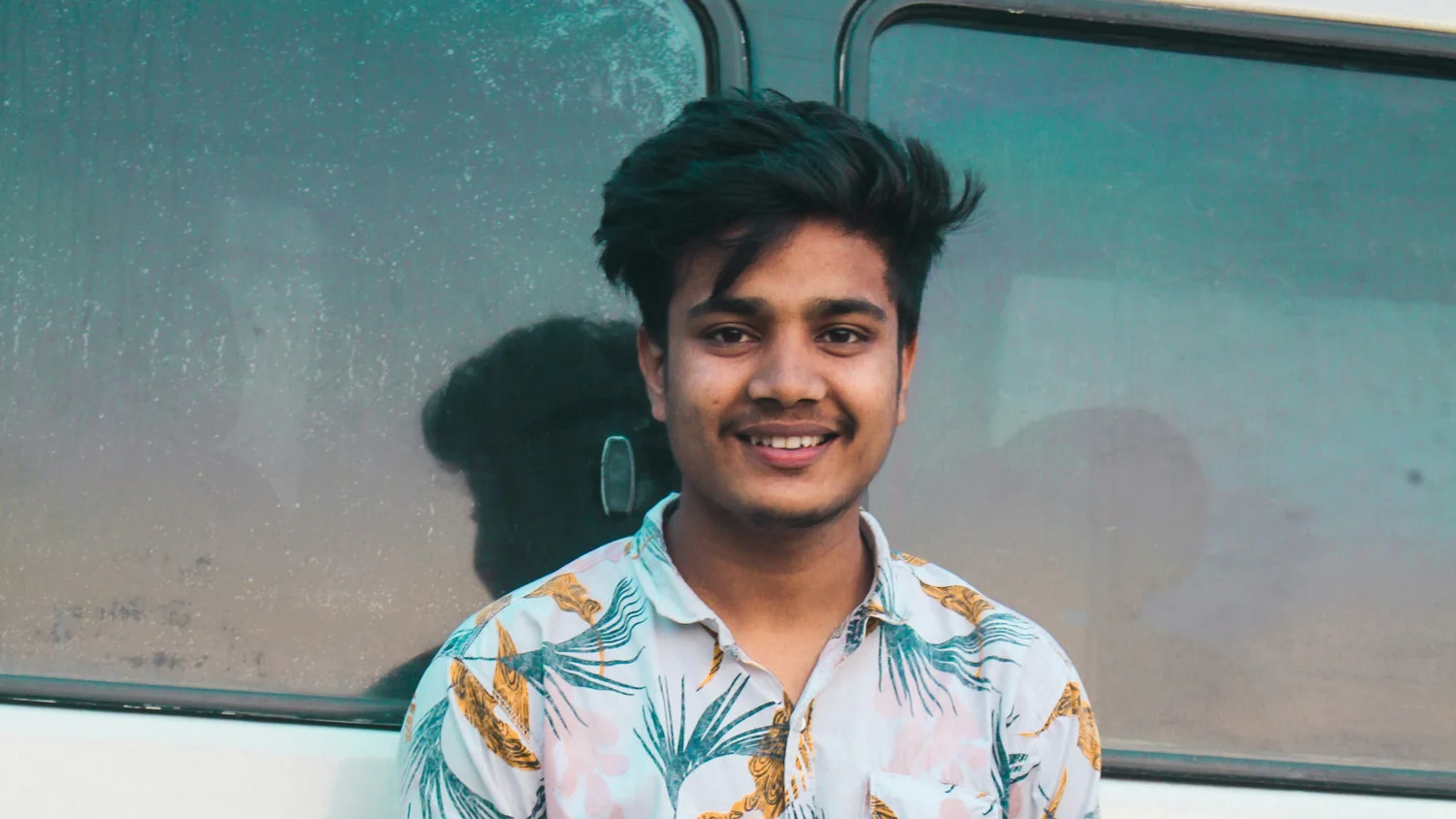 A smiling, young, male Indian type 1 diabetic. 