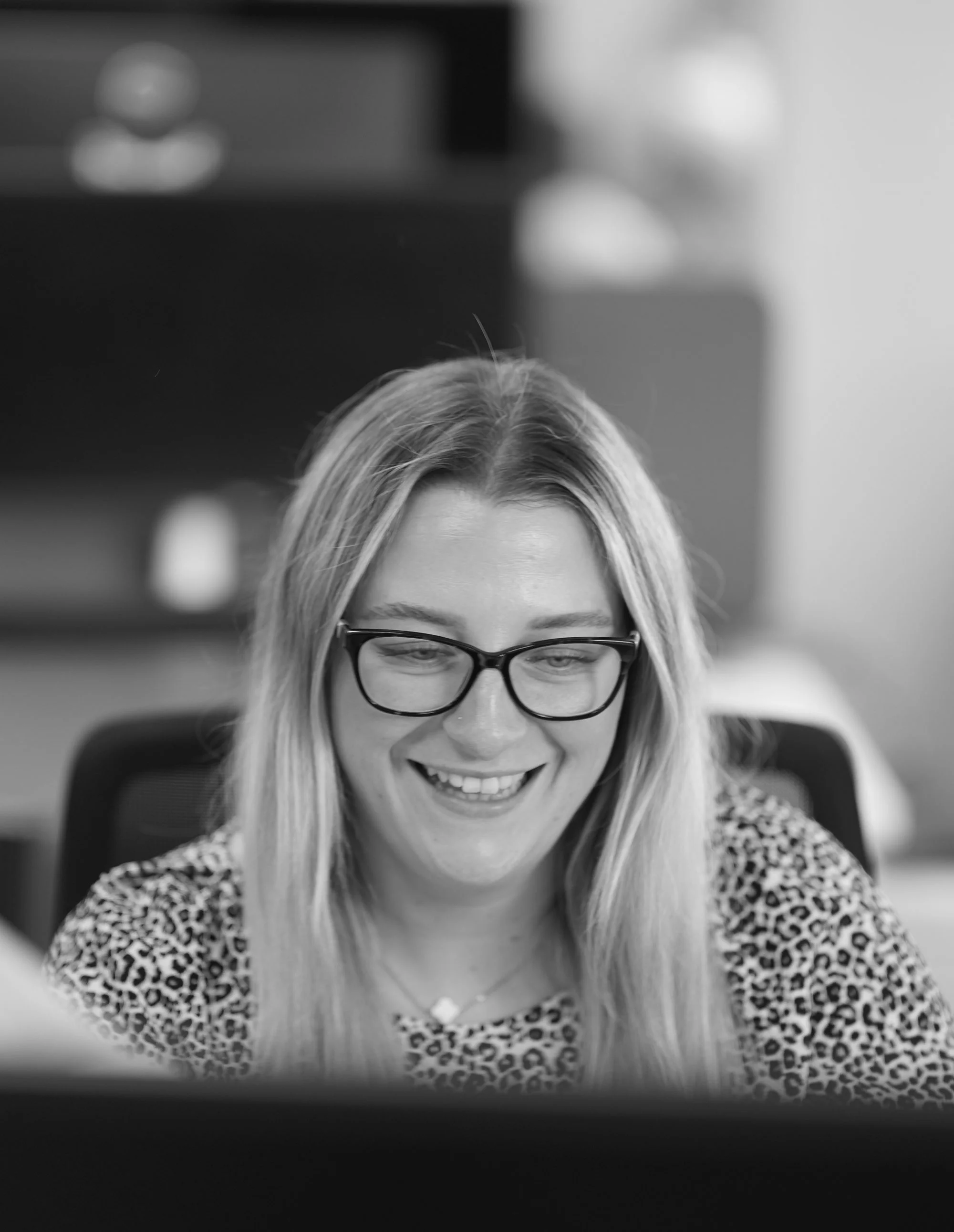 ACS employee woman smiling at screen