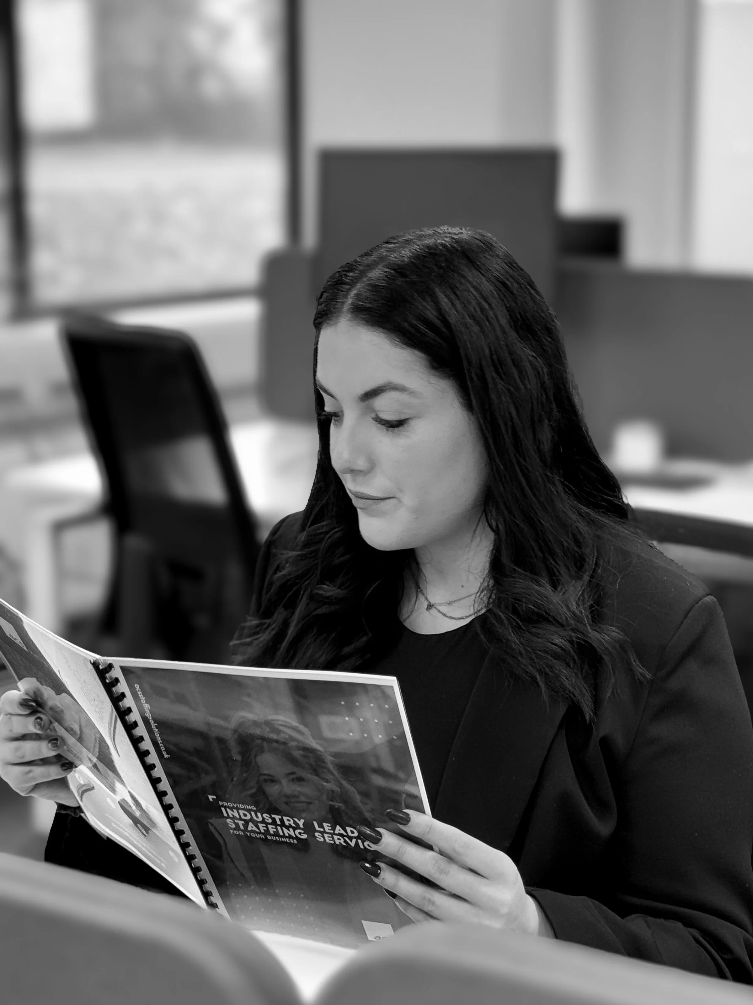 ACS employee woman holding brochure