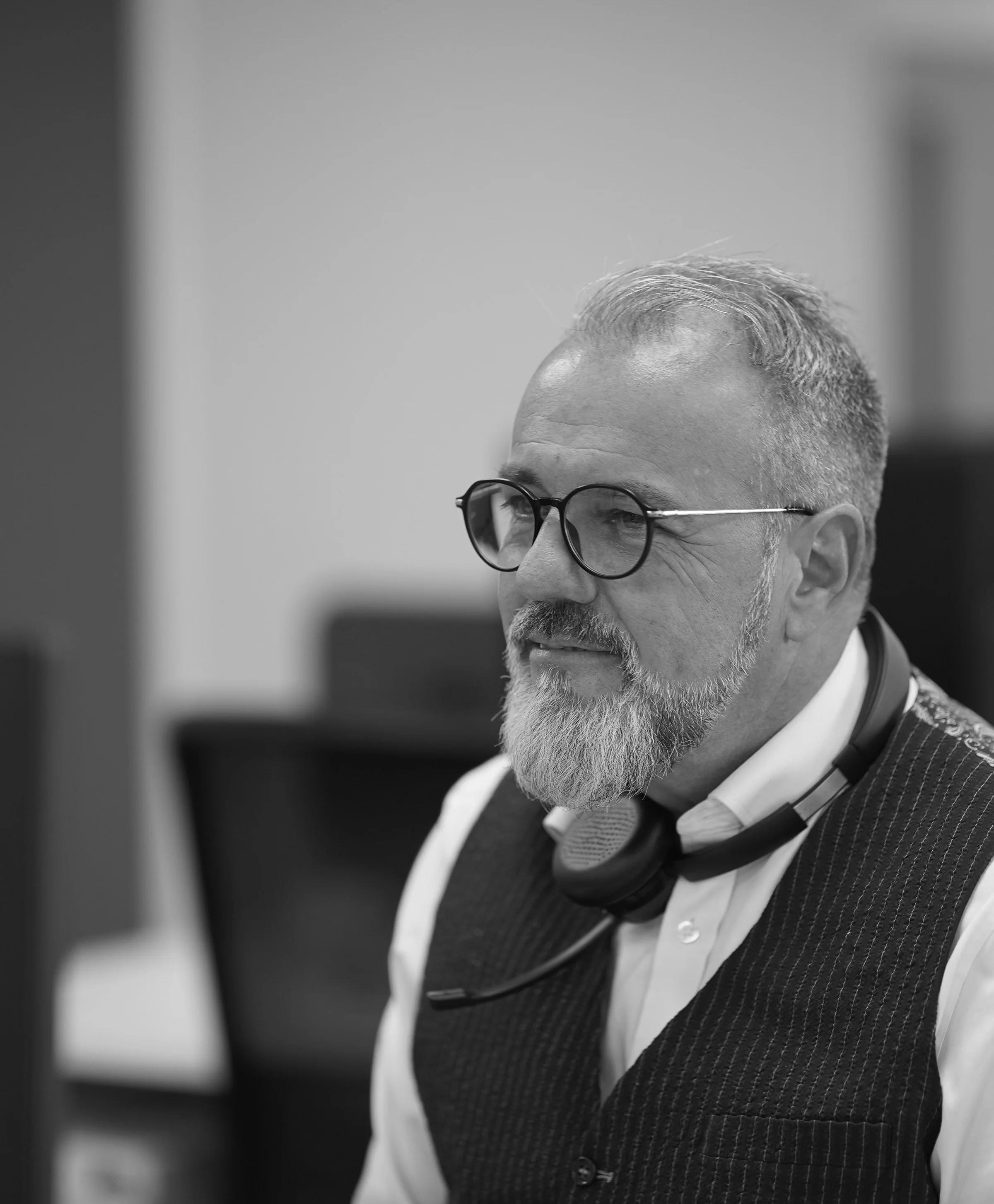 ACS employee man looking over office with headset