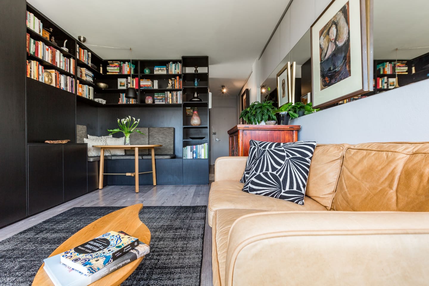 A cosy dining area is surrounded by a collection of books to peruse. Use this space to eat light meals or set up your laptop to work remotely.