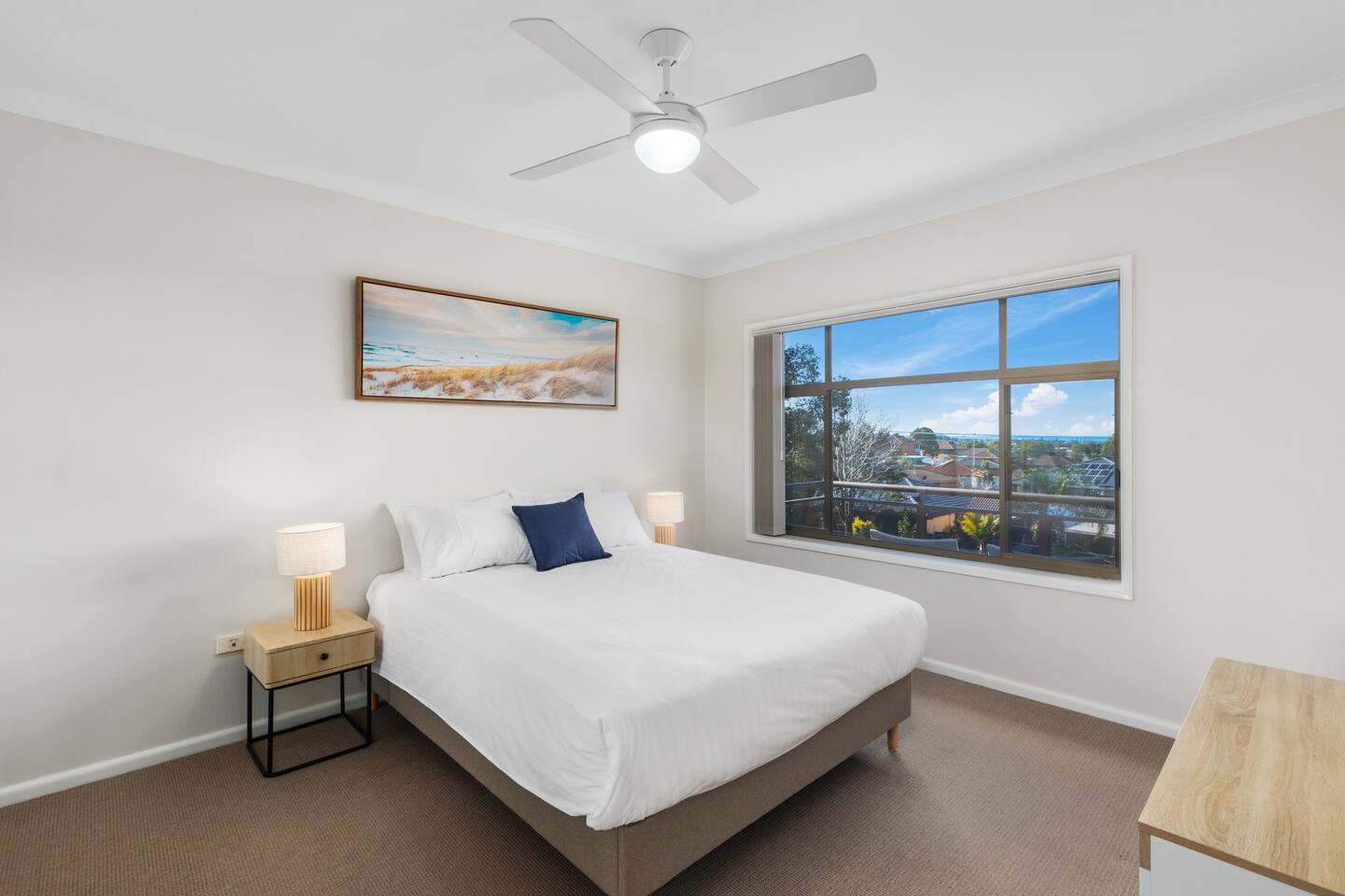 The master bedroom boasts ocean views and has a queen-sized bed and a built-in wardrobe.