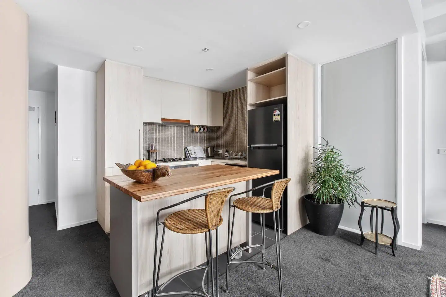 The breakfast bar and dedicated workspace at a one bedroom apartment in Melbourne