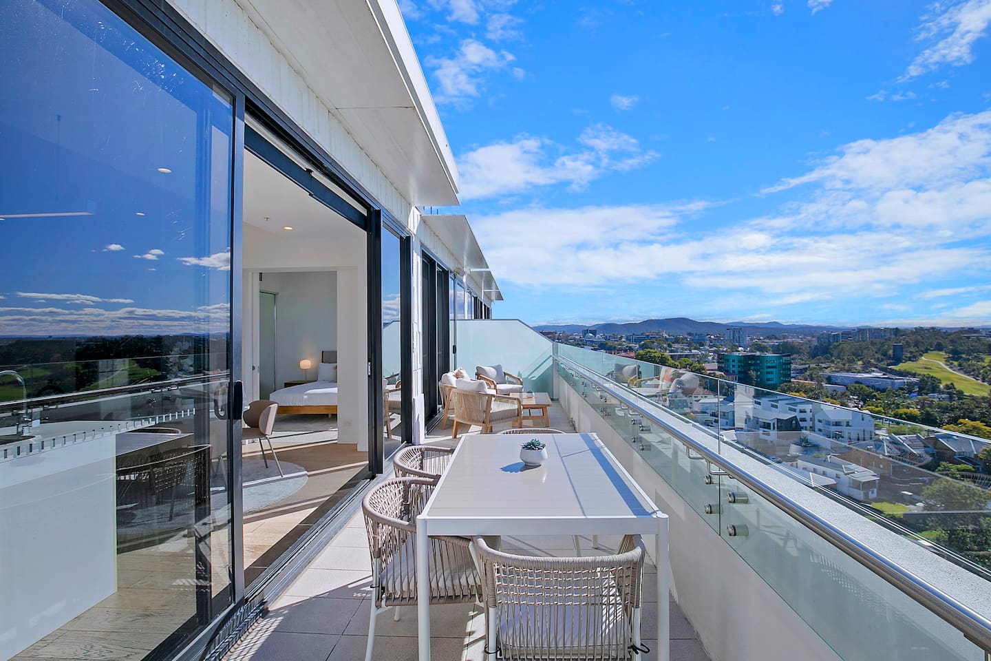 A four-seater setting on the balcony offers alfresco dining with a view.