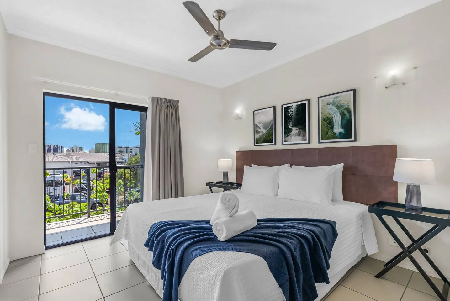 Unwind in the spacious bedroom, boasting a small balcony and a king-size bed for a restful night’s sleep.