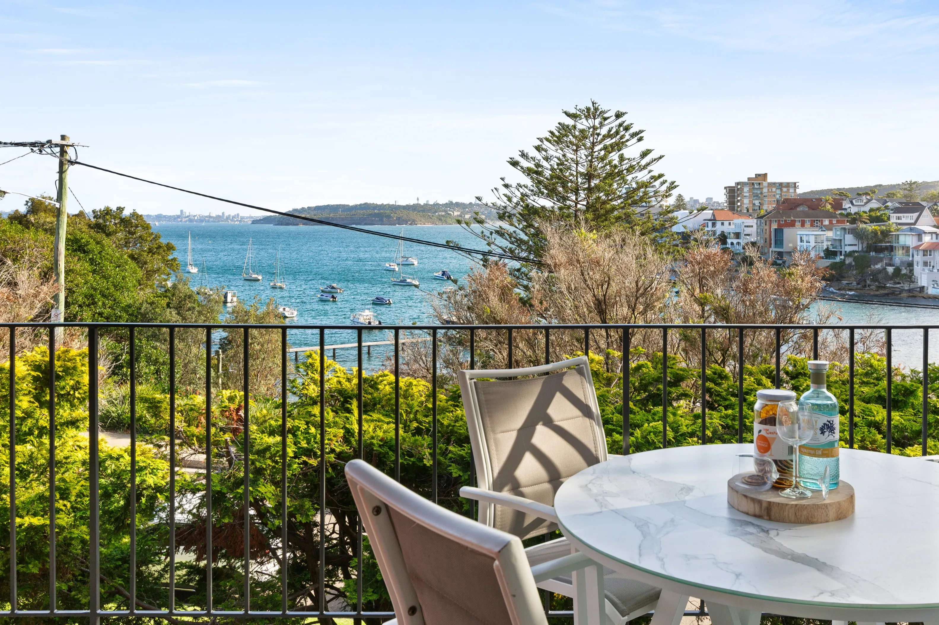 Dine alfresco on the balcony, where harbour views and leafy surrounds create a relaxed setting for long lunches or sunset drinks.