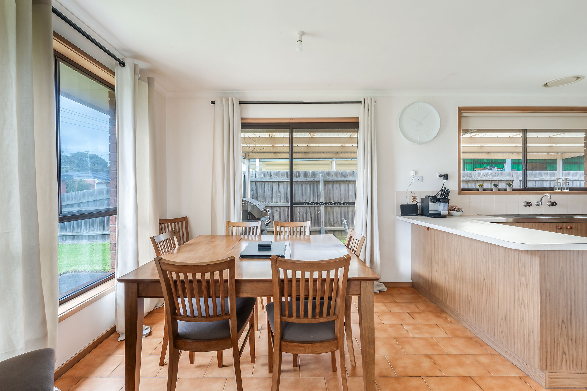 Positioned alongside the kitchen, the dining area opens directly to the alfresco space, making it easy to move between indoor and outdoor meals.