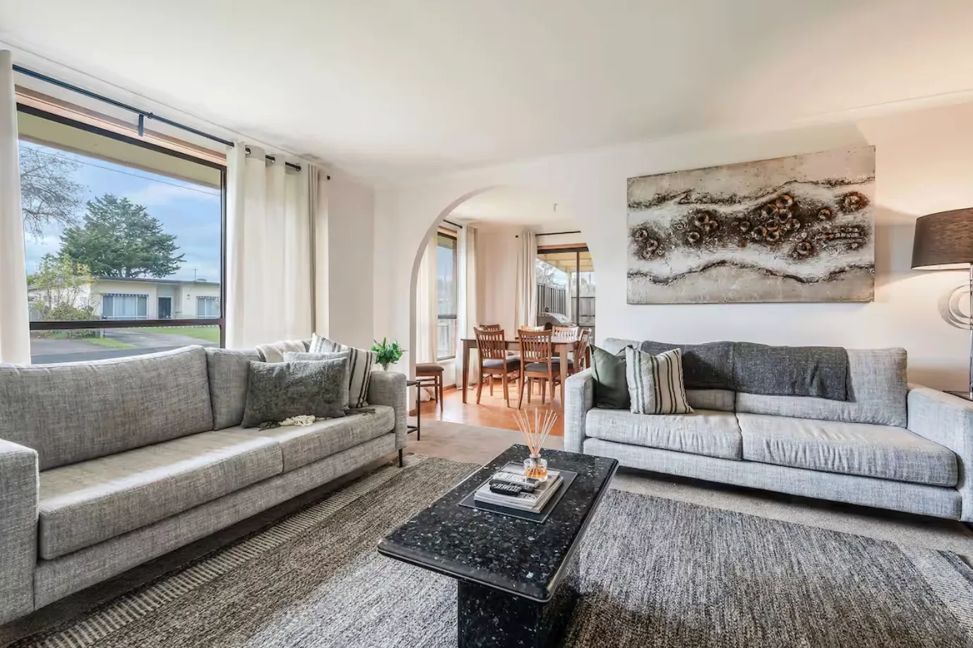 Designed for downtime, the living area pairs generous natural light with comfortable seating, a TV and a record player for leisurely afternoons indoors.
