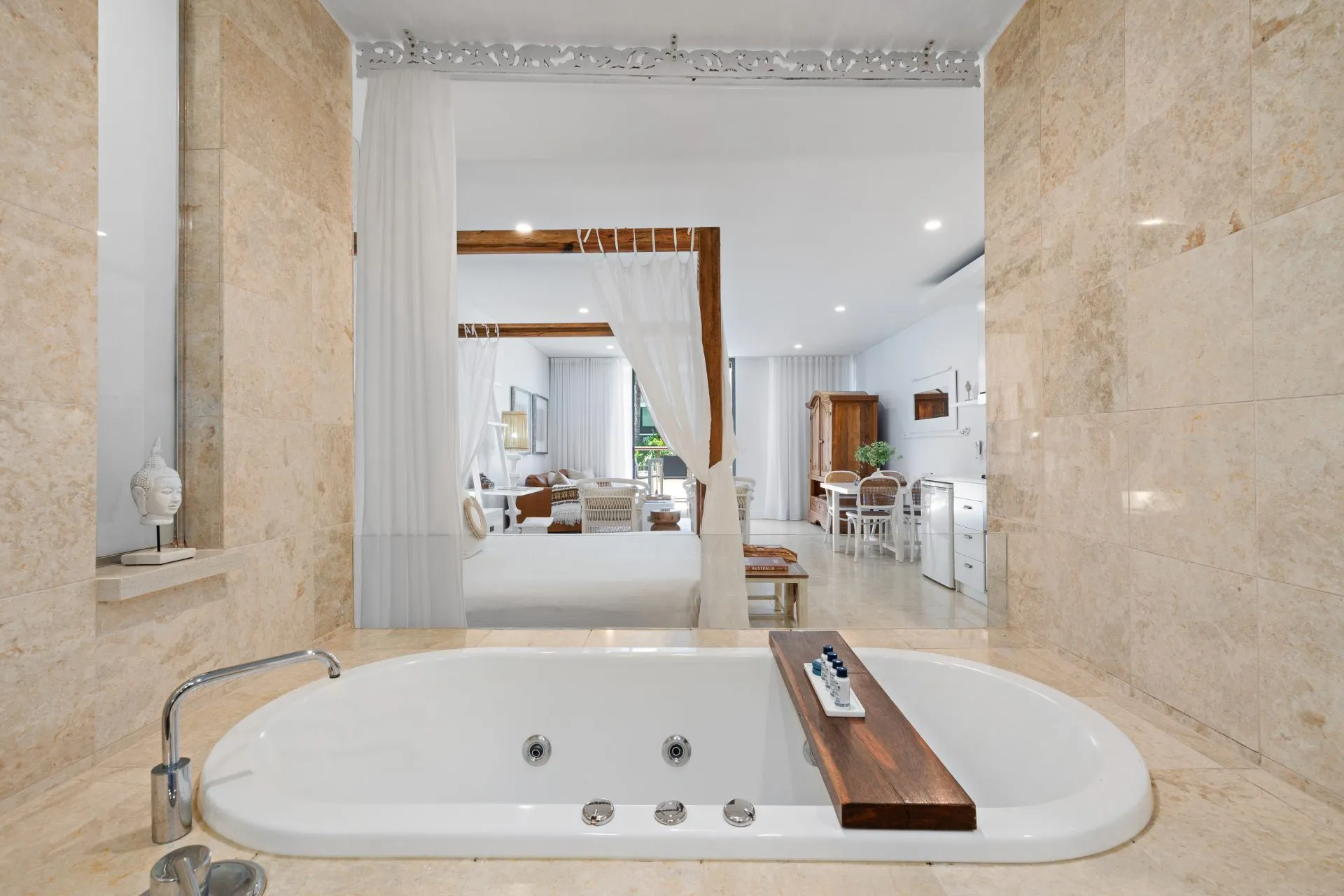A spa bath big enough for two, with the bed in view