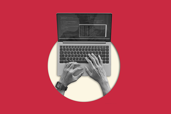 Aerial view of web designer creating a new website. typing on a laptop keyboard with coding and web development with a terminal visible on screen against a red background.