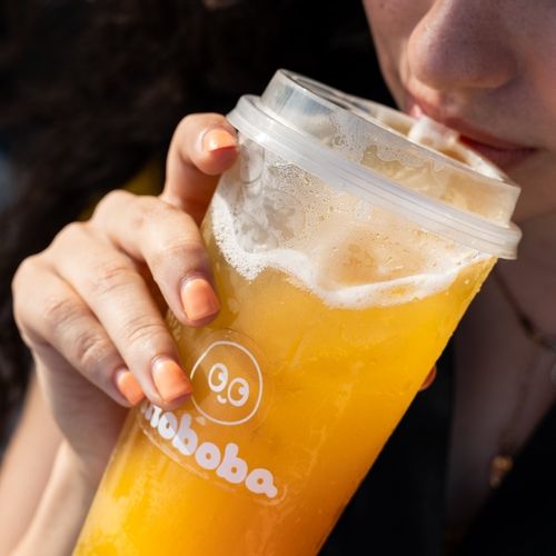 woman taking a sip of fruit tea from moboba in edinburg texas