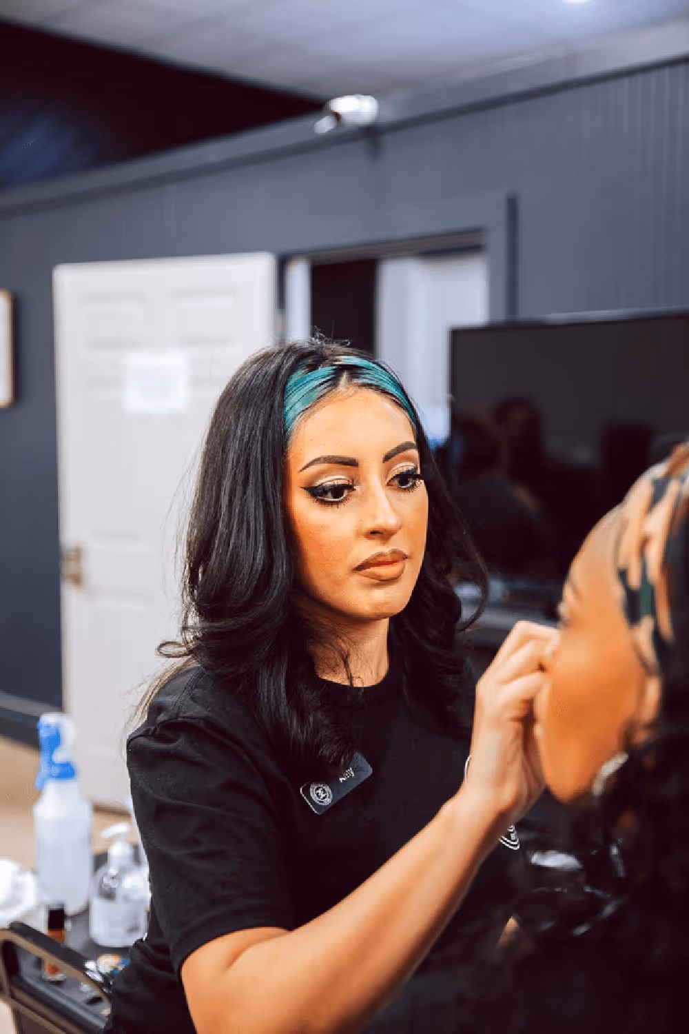 Cosmetology student applying makeup