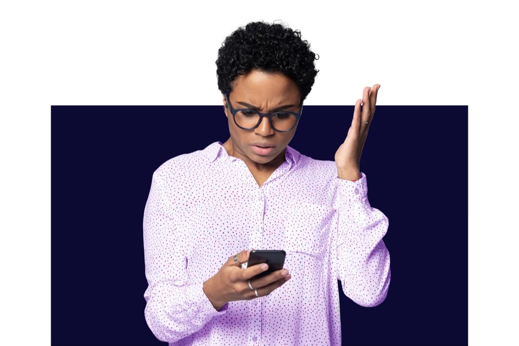 Woman looking at her mobile phone looking frustrated