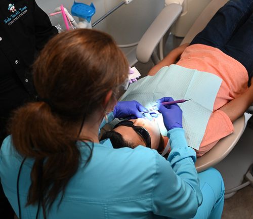 a little baby girl sitting outside