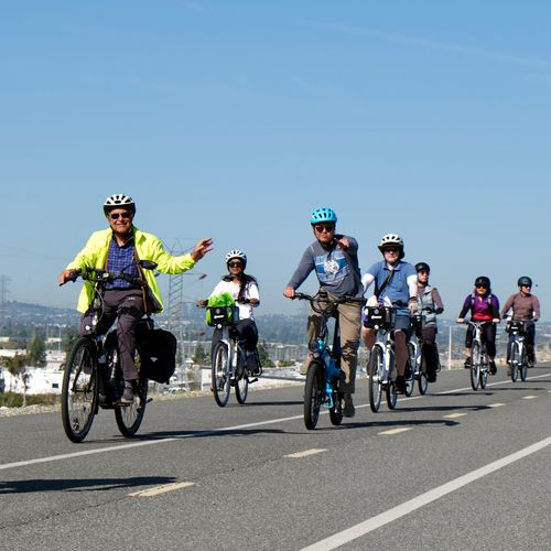 Group of cyclists riding on a bike path.