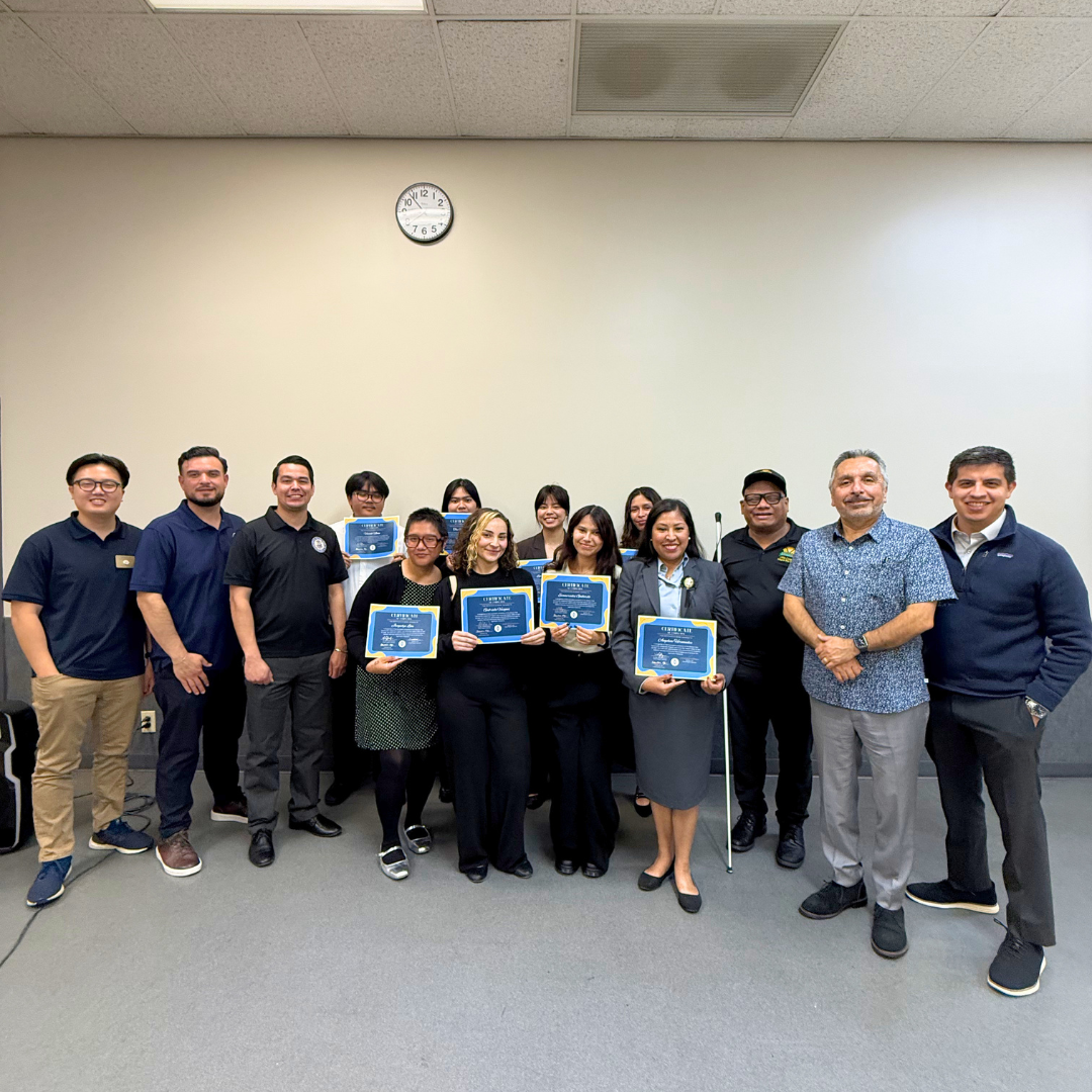 Community Leadership Program graduates pose with city representatives, program staff, and community leaders during a graduation celebration.