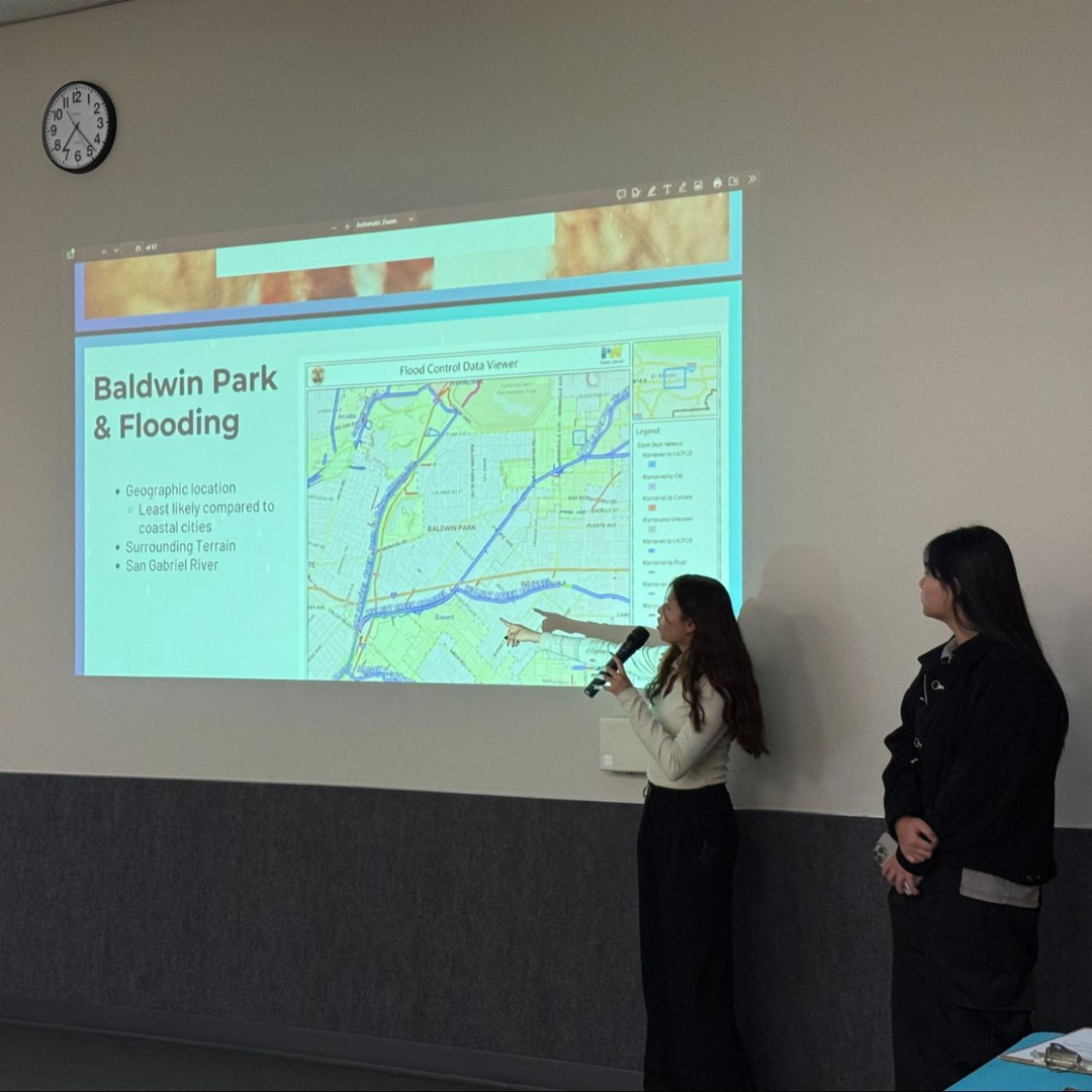 Two participants present a map of Baldwin Park while discussing flooding risks and community resilience strategies.
