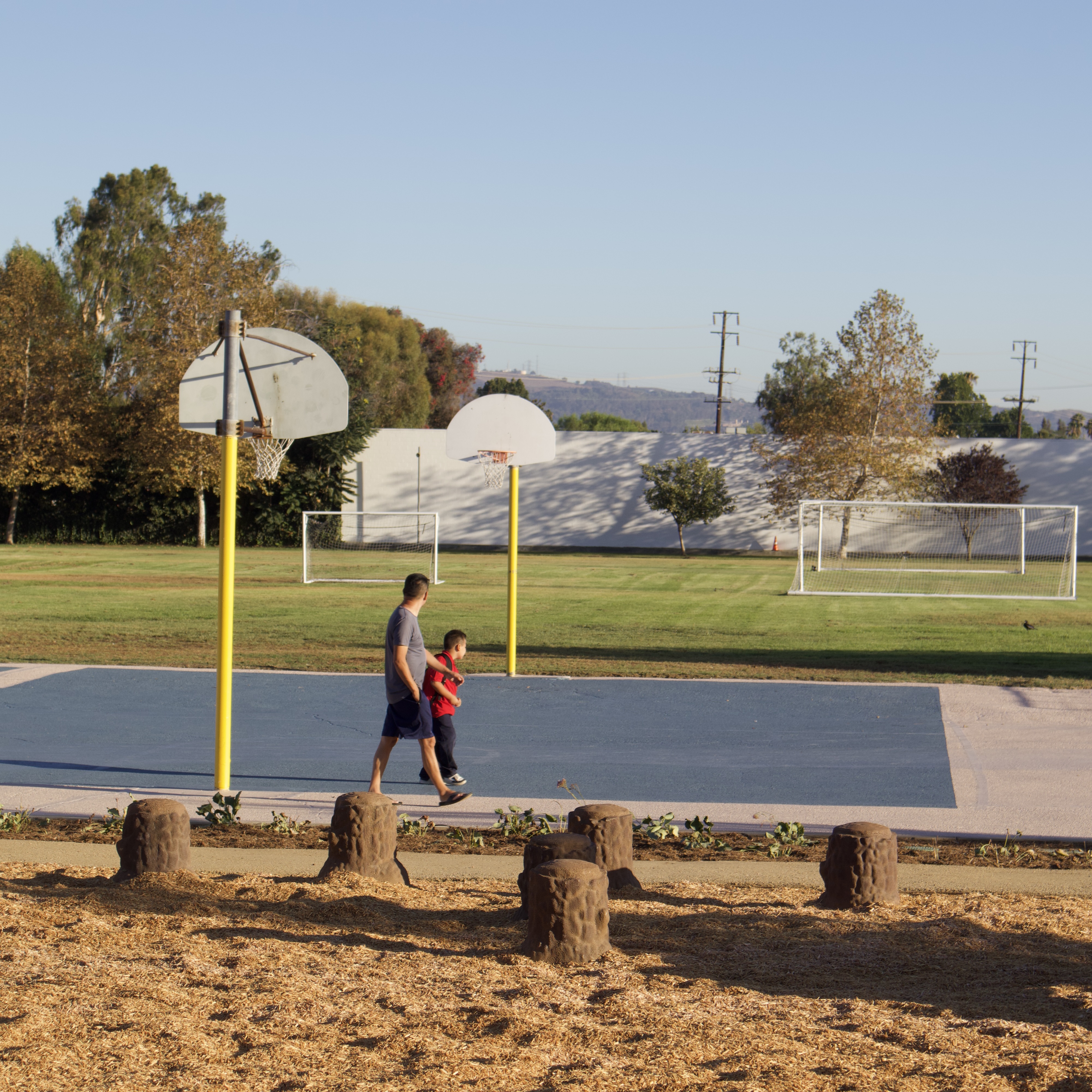 A family walks across the basketball court at Gidley School.
