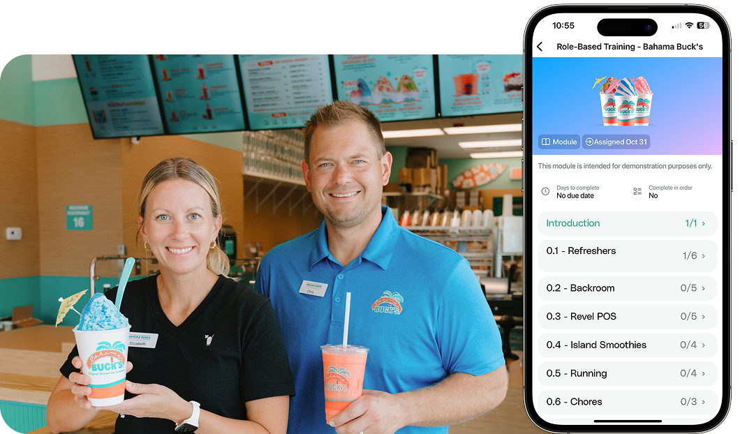 Two Bahama Buck’s employees stand inside the shop smiling and holding signature frozen drinks. Beside them, a smartphone screen displays an Opus role-based training module for Bahama Buck’s, showing sections like Refreshers, Backroom, POS, Island Smoothies, and Running.