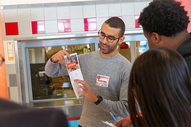 man talking with students