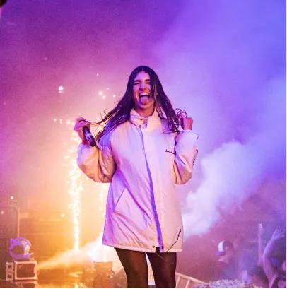 An artist smiling on stage