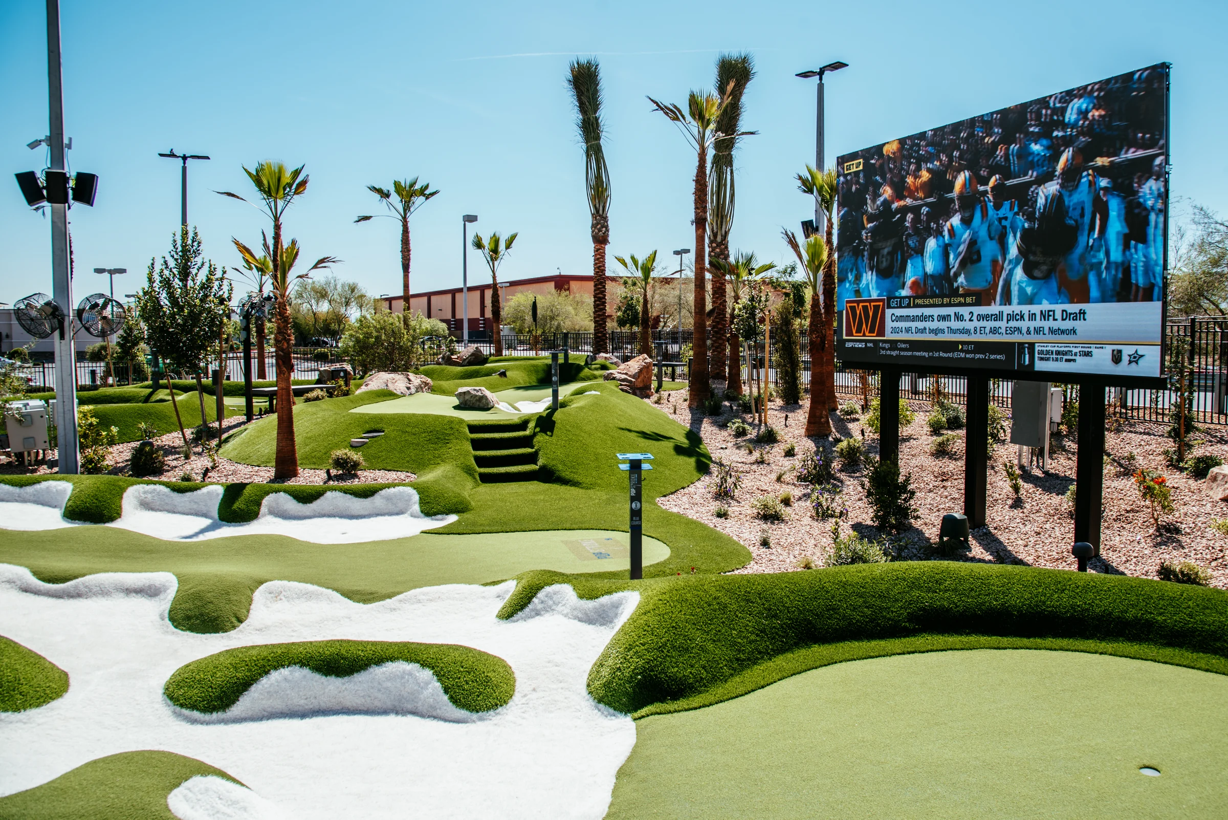 PopStroke landscaped putting greens and synthetic-turf bunkers