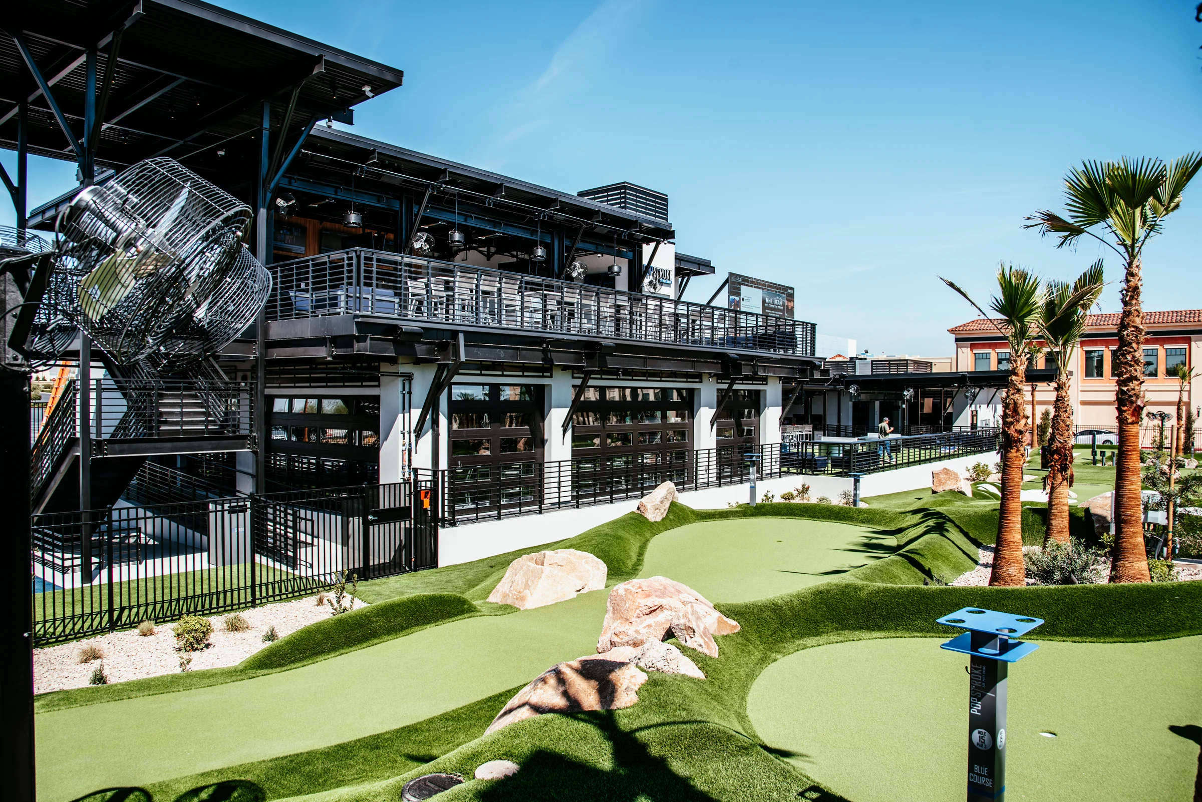 PopStroke steel balconies and covered terraces beside the putting course