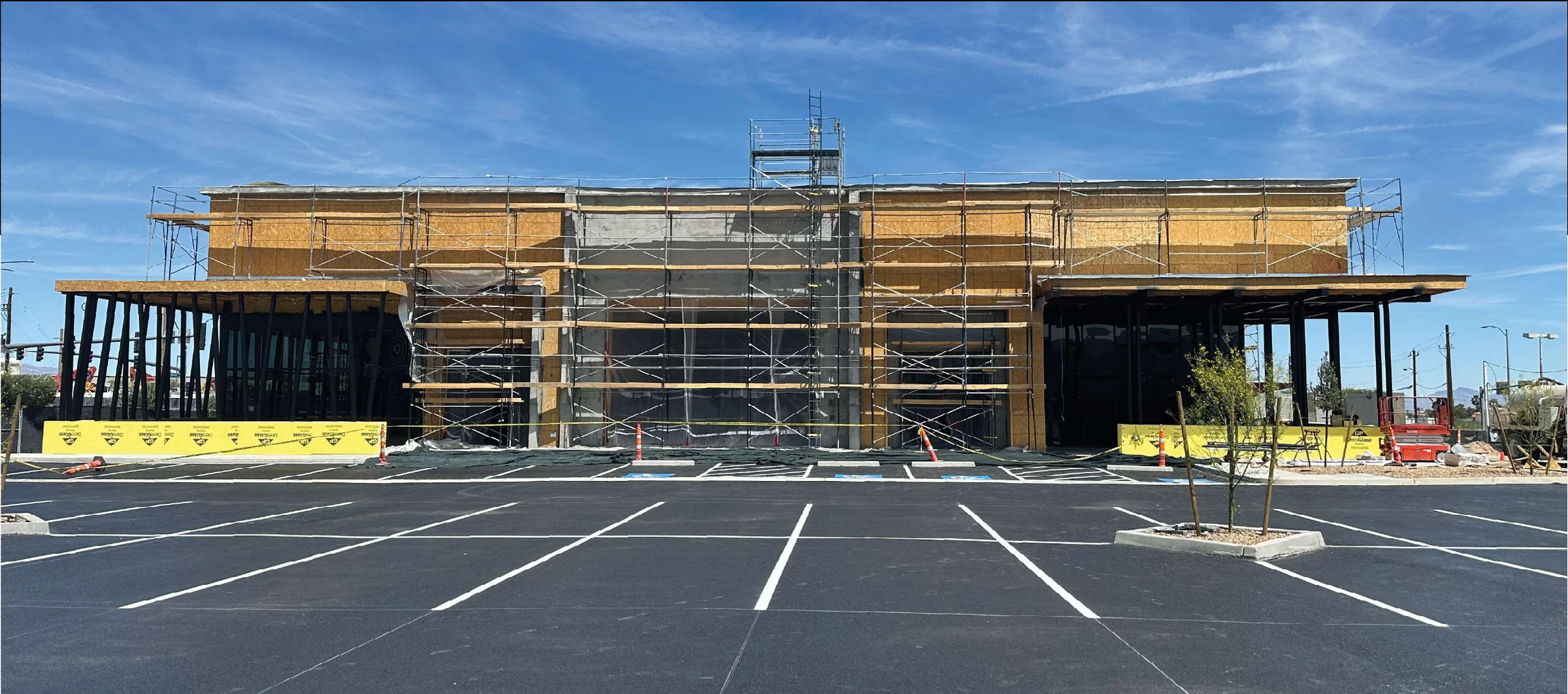 Town Square Pad 2 during construction, with scaffolded facade and paved parking