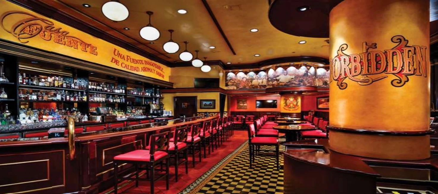 Casa Fuente bar with red seating and a patterned floor at the Forum Shops
