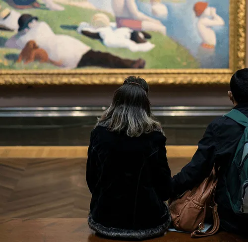 Person looking at artwork on a wall