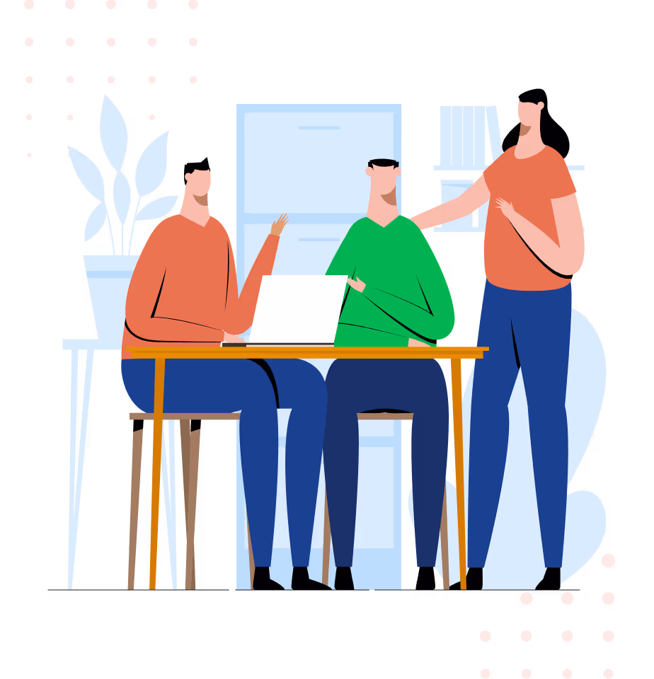 Two people sitting at a table with a laptop and a third person standing next to them in an office setting.