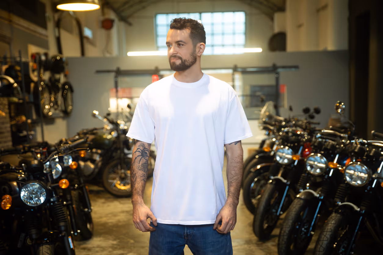 Young man in motorcycle garage wearing white t-shirt