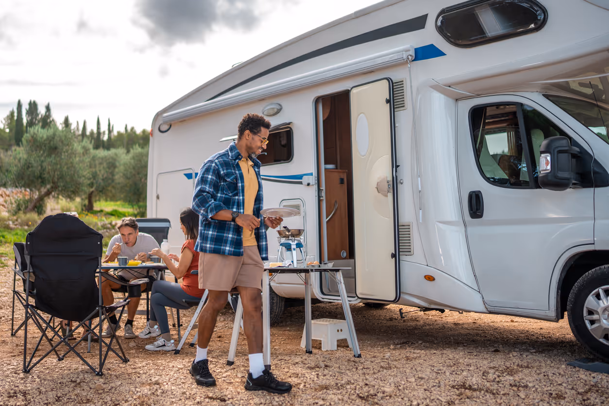 Casual Weekend Traveler Cooks Breakfast Near Parked Motorhome By Coast