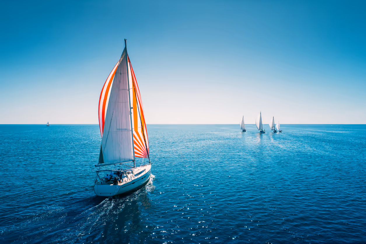 Regatta sailing ship yachts with white sails at opened sea